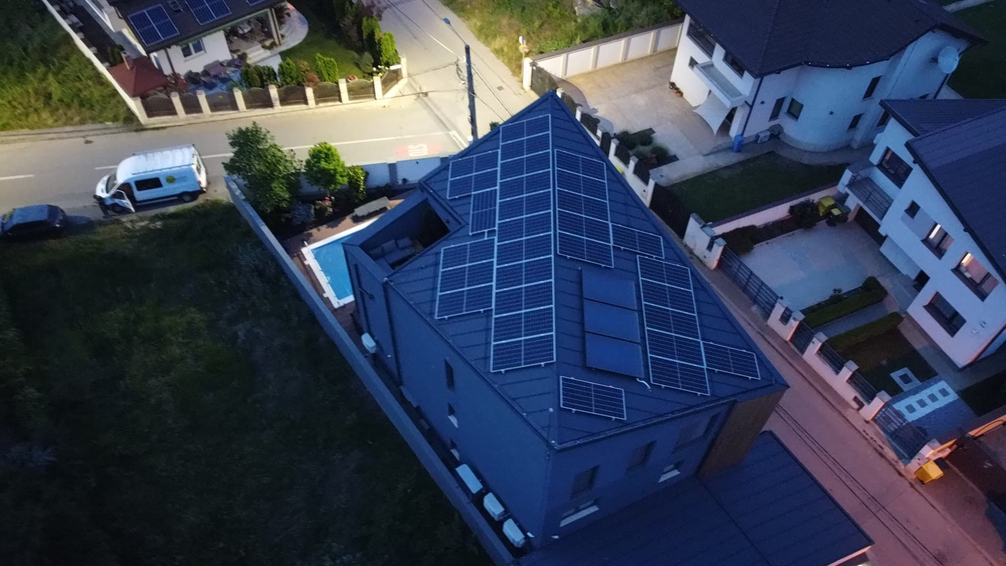 Locuință cu panouri fotovoltaice montate pe acoperiș, fotografiată din dronă
